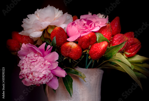 Bouquet of peonies with strawberries. Strawberry bouquet close-up