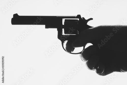 Hand holding revolver isolate on white background.
