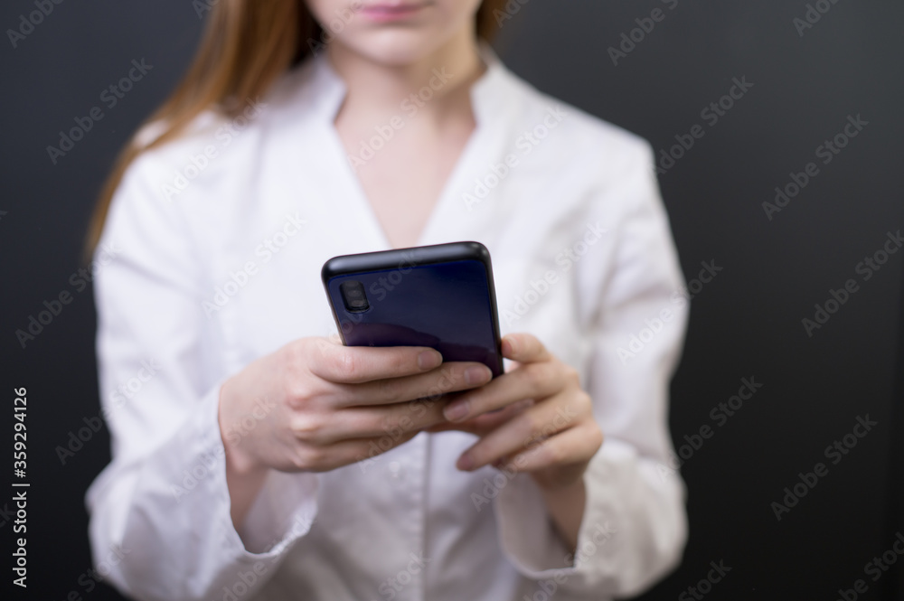 Young female doctor with phone