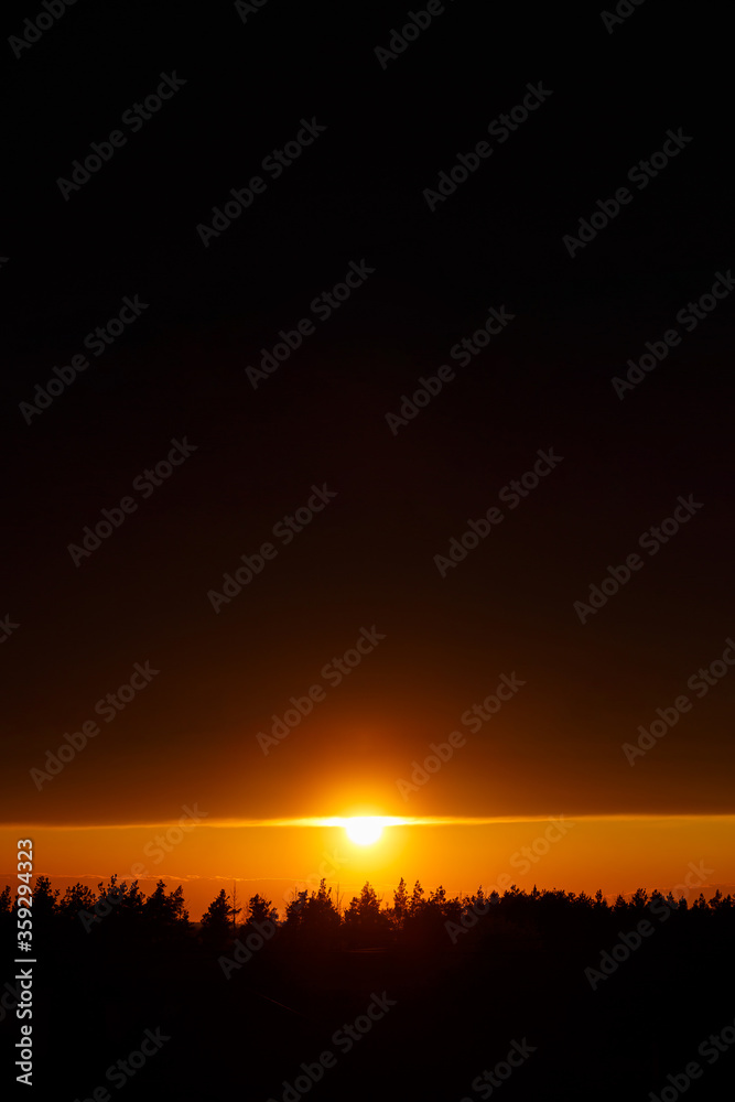 Beautiful view, sunset in orange, the sun goes over the horizon