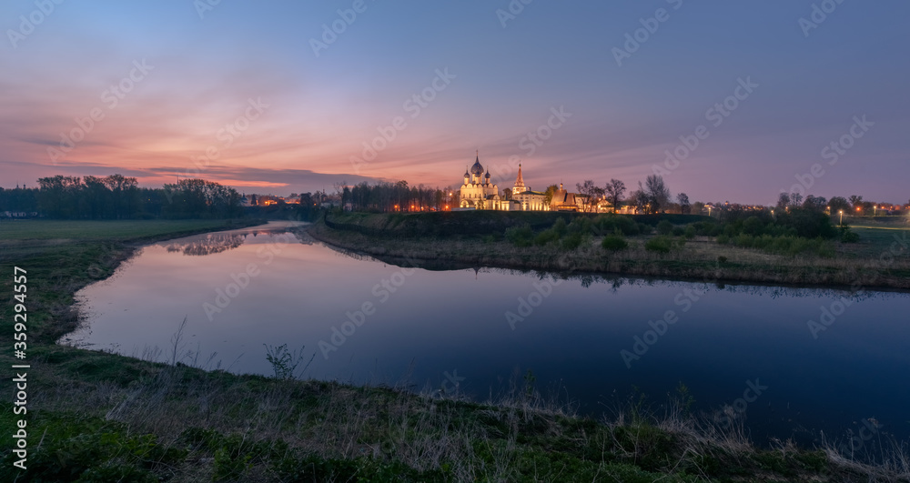 Spring landscape in early morning in the old Russian town Suzdal through the river Kamenka with temples and buildings of the Kremlin