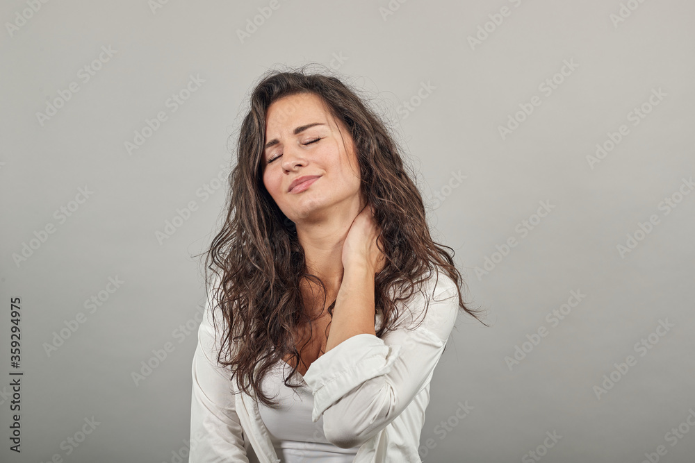 Tilting face to side, gently touching neck with a hand, beauty redefined, good looking, keeps fingers on head, touches soft skin, people and health, profile of satisfied. Young attractive woman Tilting face to side, gently touching neck with a hand, beauty redefined, good looking, keeps fingers on head, touches soft skin, people and health, profile of satisfied. Young attractive woman