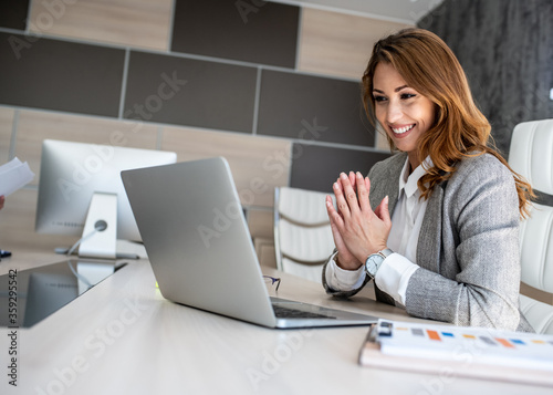 Smiling businesswoman discussing about business with her colleagues