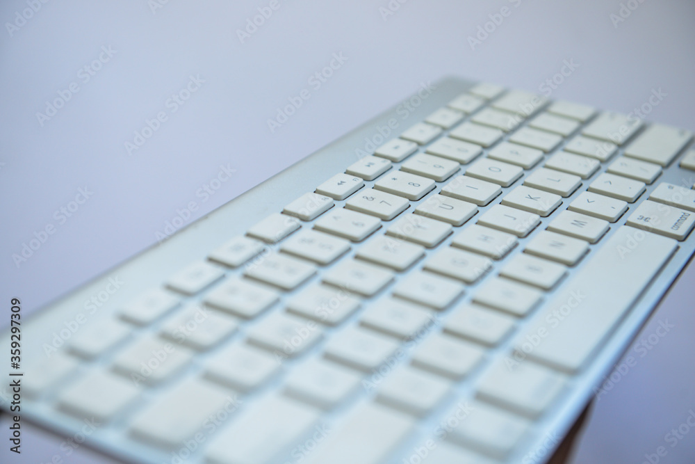 Modern aluminum computer keyboard isolated on white background with mouse and visiting card 