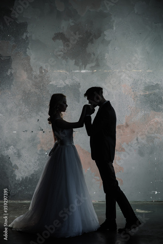 Art fashion studio photo of wedding couple silhouette groom and bride on colors background. Art Wedding style.
