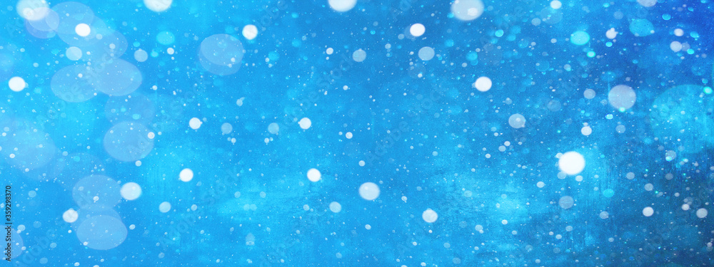 Snowy snowflakes isolated on blue sky - winter weather snow background
