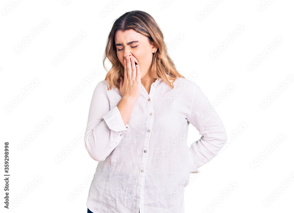 Young caucasian woman wearing casual clothes bored yawning tired covering mouth with hand. restless and sleepiness. Young caucasian woman wearing casual clothes bored yawning tired covering mouth with hand. restless and sleepiness.
