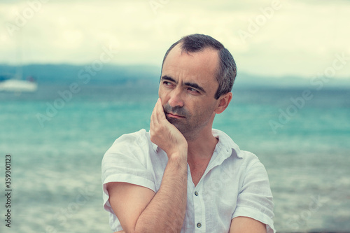 man on the beach taking deep breath enjoying fresh air freedom