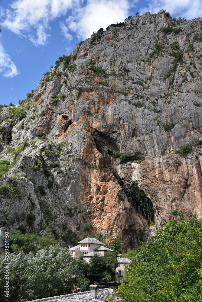 Blagaj / Bosnia and Herzegovina - 06 June 2020: Dervish tekke bellow huge cliff. Religion touristic place in Herzegovina. 
