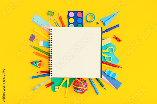 School notebook and various supplies around. Back to school concept..
