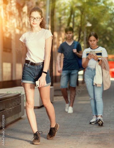 Full length portrait of teen girl walking on summer day