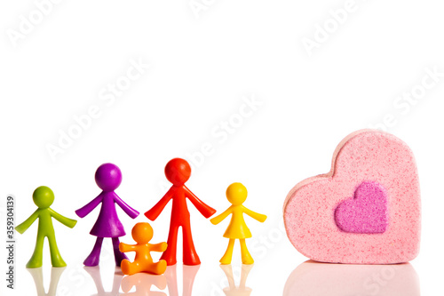 Happy family colored figurines and pink heart on a white background