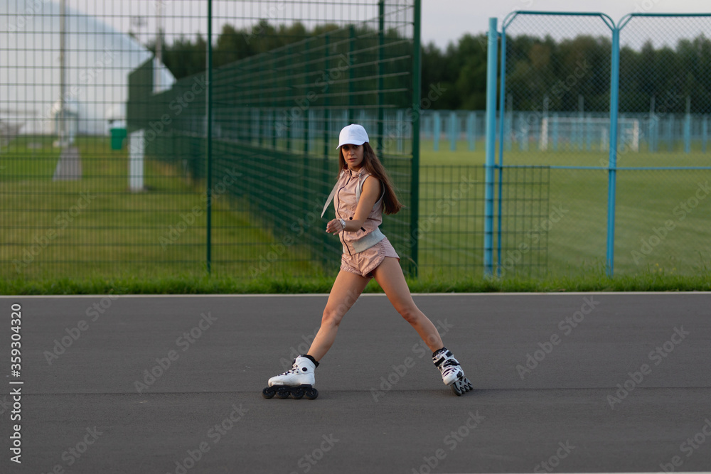 Girl roller skating in the park. Sports girl roller skating. Girl roller skating in the park. Sports girl roller skating.