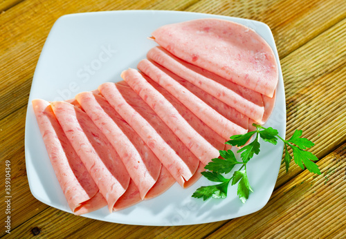 Sliced ham on wooden background