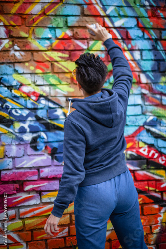 girl draws graffiti on the wall