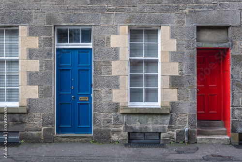 Blue and red door of tenement in Edinburgh city, UK