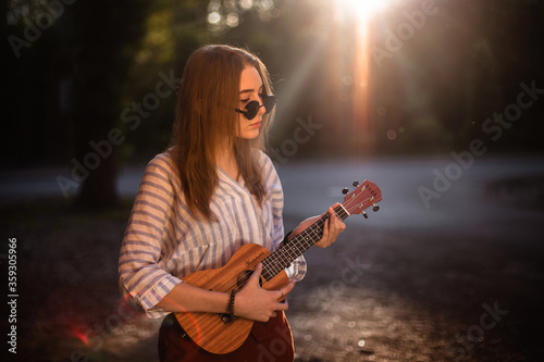 girl with ukulele on the street