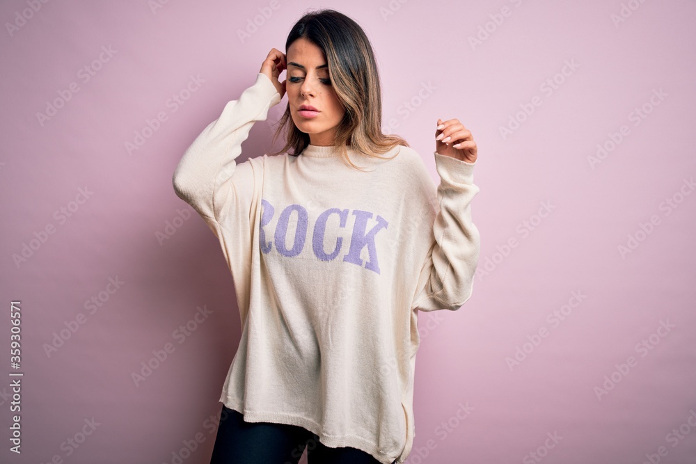 Young beautiful woman wearing fashion urban clothes, model wearing casual street style standing over pink background Young beautiful woman wearing fashion urban clothes, model wearing casual street style standing over pink background