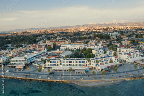 Aerial view of Paphos embankment in Cyprus. Coastline with hotels, cafes, restaurants and walking area, view from above.