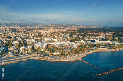 Aerial view of Paphos embankment in Cyprus. Coastline with hotels, cafes, restaurants and walking area, view from above.