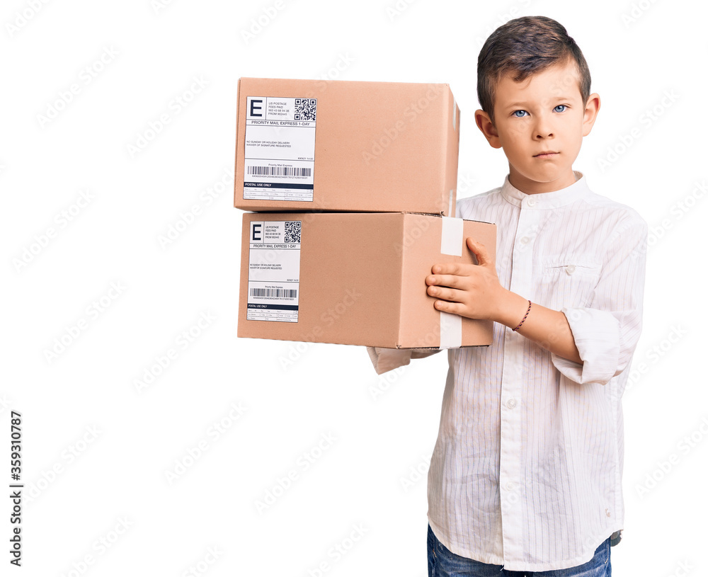 Cute blond kid holding delivery package thinking attitude and sober expression looking self confident Cute blond kid holding delivery package thinking attitude and sober expression looking self confident