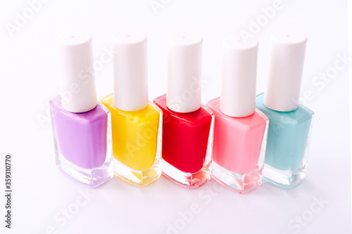 Group of nail polishes of different colors on white background