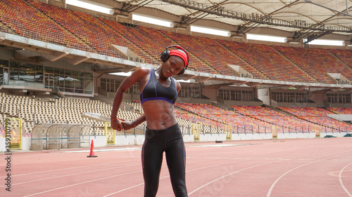 Athletic black female in an empty sports stadium