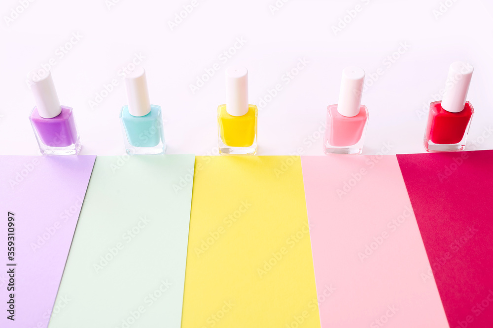 Group of nail polishes of different colors on colorful background. Group of nail polishes of different colors on colorful background.