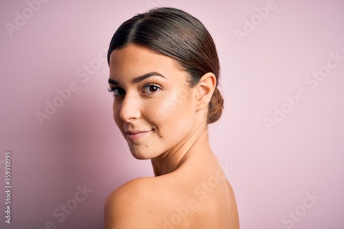 Close up of young beautiful woman with clear and pure skin. Perfect and clean skincare wearing natural makeup. Smiling happy looking fresh and healthy.