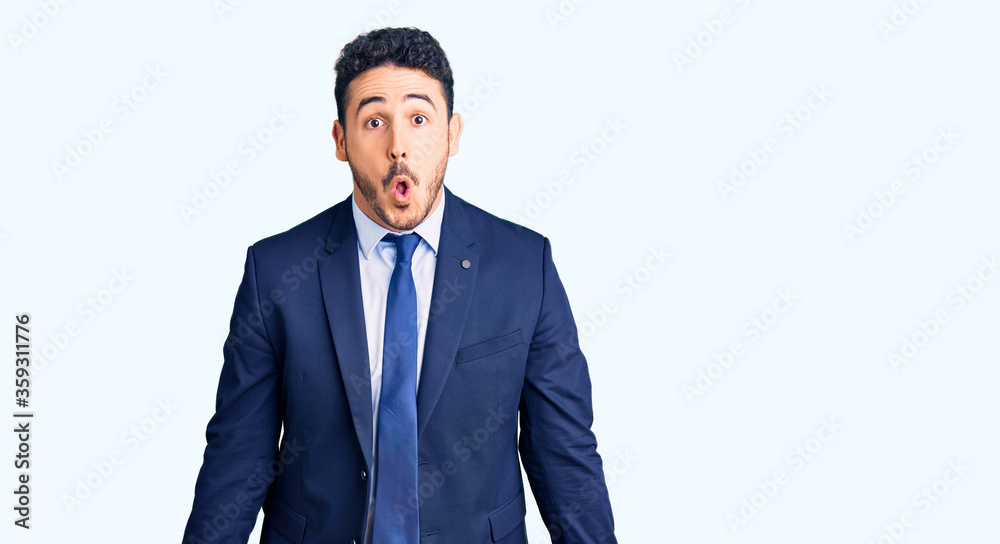 Young hispanic man wearing business clothes scared and amazed with open mouth for surprise, disbelief face Young hispanic man wearing business clothes scared and amazed with open mouth for surprise, disbelief face