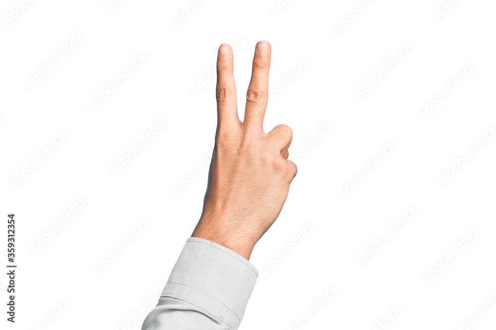 Hand of caucasian young man showing fingers over isolated white background counting number 2 showing two fingers, gesturing victory and winner symbol Hand of caucasian young man showing fingers over isolated white background counting number 2 showing two fingers, gesturing victory and winner symbol