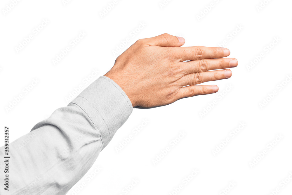 Hand of caucasian young man showing fingers over isolated white background stretching and reaching with open hand for handshake, showing back of the hand Hand of caucasian young man showing fingers over isolated white background stretching and reaching with open hand for handshake, showing back of the hand