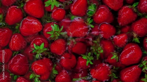 ripe berry strawberries fall into the water slow motion photo