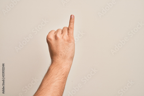 Hand of caucasian young man showing fingers over isolated white background showing little finger as pinky promise commitment, number one © Krakenimages.com