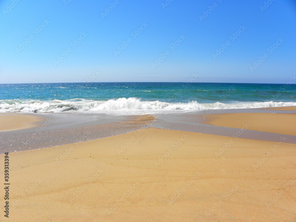 Atlantic Ocean, Santa Cruz Beach, Portugal. Turquoise ocean and yellow sand. Travel, vacation, vacation, paradise, relaxation.