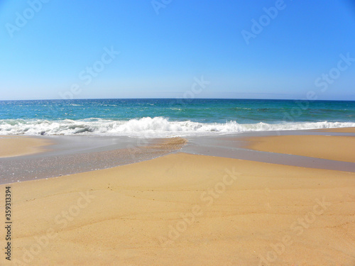 Atlantic Ocean, Santa Cruz Beach, Portugal. Turquoise ocean and yellow sand. Travel, vacation, vacation, paradise, relaxation.
