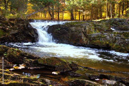Autumn waterfall with fall foliage on the Falls River in the small town of L'Anse in the Upper Peninsula of Michigan.
