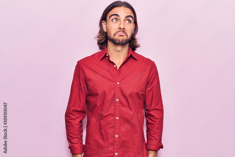 Fototapeta premium Young handsome man wearing business clothes smiling looking to the side and staring away thinking.