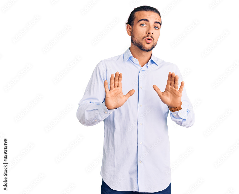 Young handsome man wearing business clothes moving away hands palms showing refusal and denial with afraid and disgusting expression. stop and forbidden.