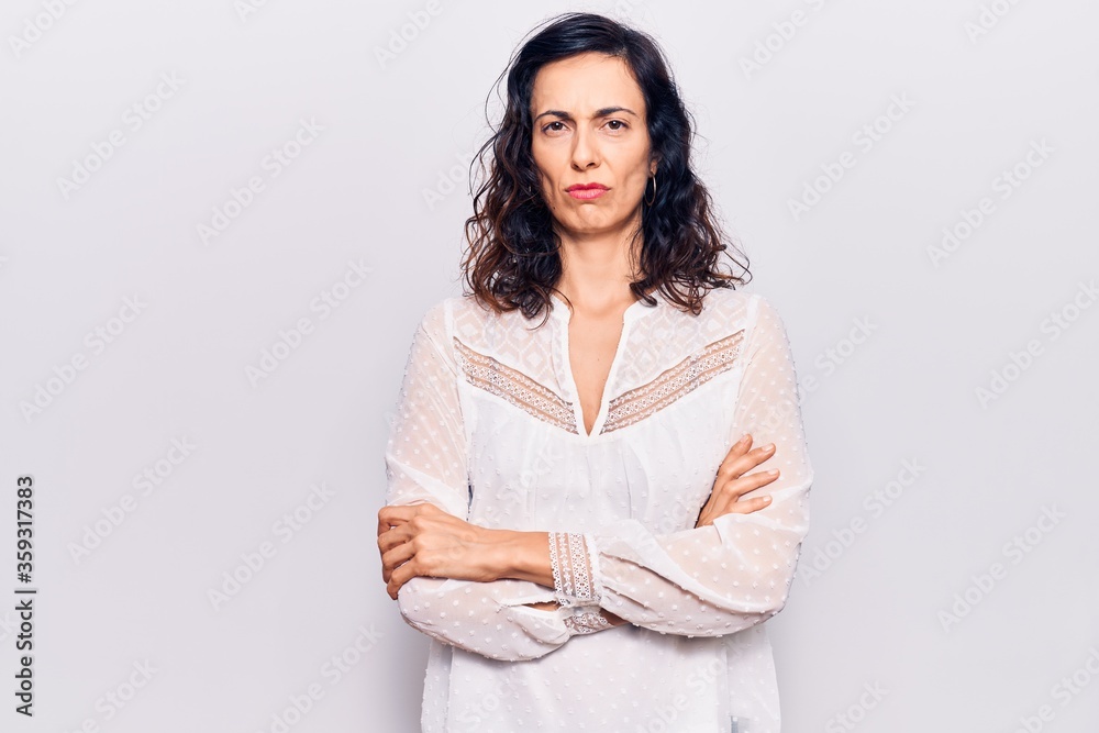 Young beautiful hispanic woman wearing casual clothes skeptic and nervous, disapproving expression on face with crossed arms. negative person. Young beautiful hispanic woman wearing casual clothes skeptic and nervous, disapproving expression on face with crossed arms. negative person.