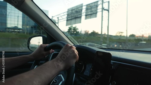Wallpaper Mural View from the interior cabin of a car, driver holding the steering wheel of his vehicle while driving on the highway. Torontodigital.ca