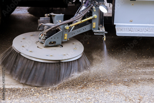 Street sweeper machine cleaning the streets in utility service of the town.