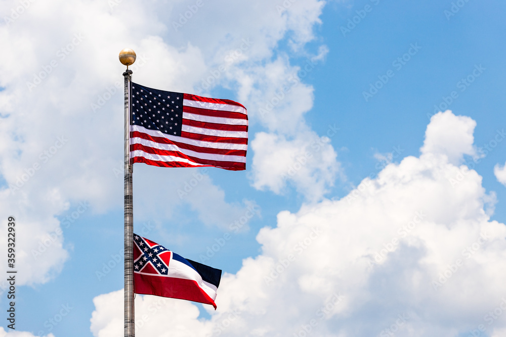 State of Mississippi flag and United States flag waving in the wind