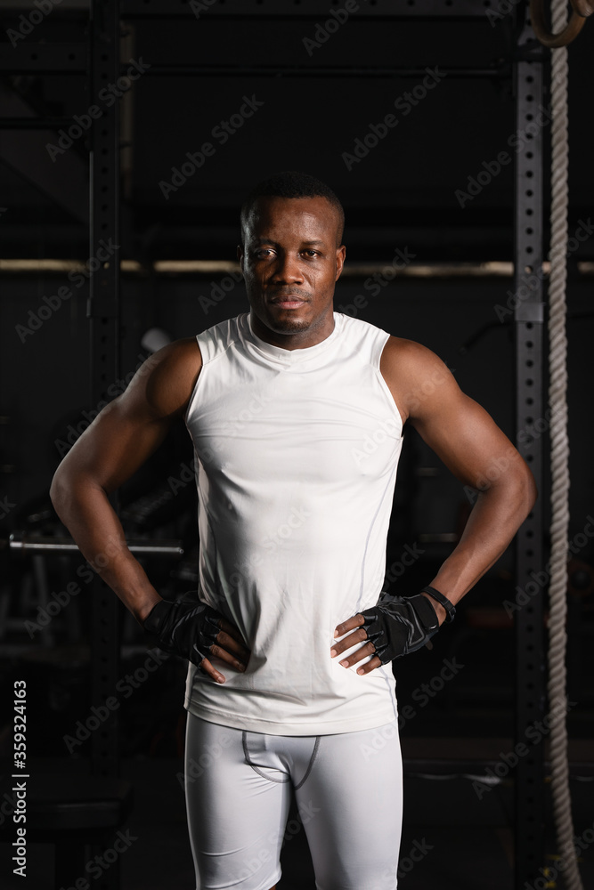 african american athletics man posing in gym and fitness club