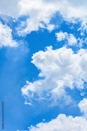 Fototapeta Naklejka Na Ścianę i Meble -  beautiful blue sky with white clouds in a morning vertical composition