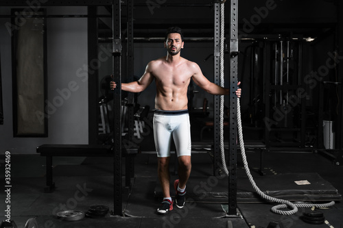 caucasian athletics man posing in gym and fitness club