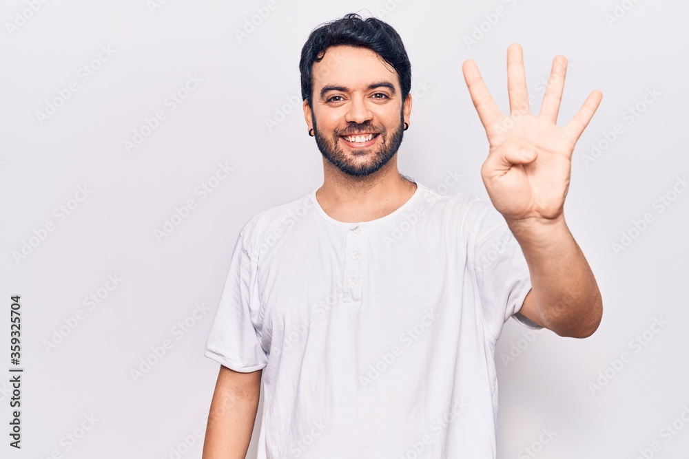Young hispanic man wearing casual clothes showing and pointing up with fingers number four while smiling confident and happy. Young hispanic man wearing casual clothes showing and pointing up with fingers number four while smiling confident and happy.