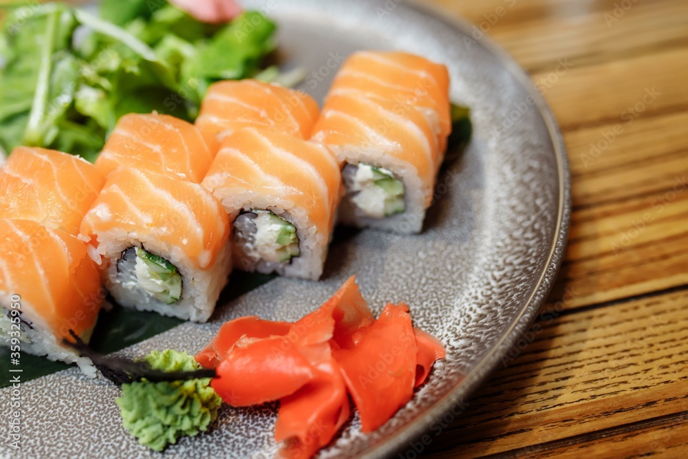 Philadelphia Maki Sushi made of Philadelphia Cream Cheese inside, Fresh Raw Salmon outside. Garnished with Sauce Philadelphia Maki Sushi made of Philadelphia Cream Cheese inside, Fresh Raw Salmon outside. Garnished with Sauce