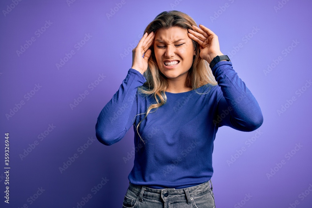 Young beautiful blonde woman wearing casual t-shirt over isolated purple background with hand on headache because stress. Suffering migraine. Young beautiful blonde woman wearing casual t-shirt over isolated purple background with hand on headache because stress. Suffering migraine.