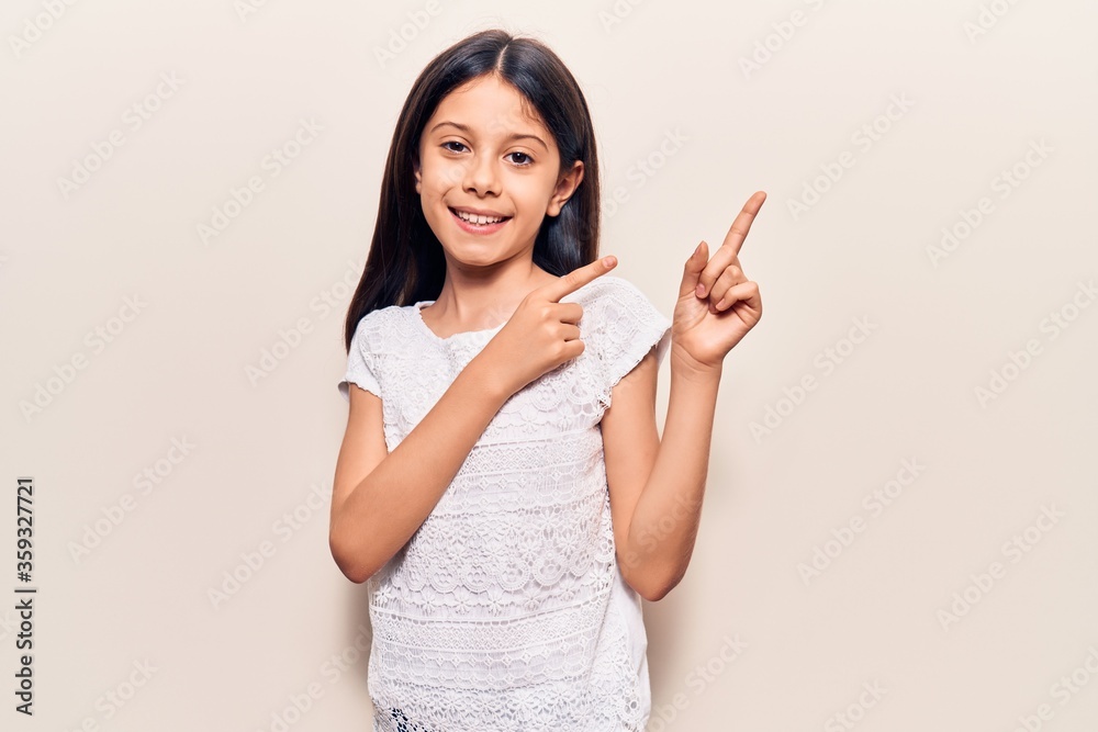 Beautiful child girl wearing casual clothes with open hand doing stop sign with serious and confident expression, defense gesture Beautiful child girl wearing casual clothes with open hand doing stop sign with serious and confident expression, defense gesture